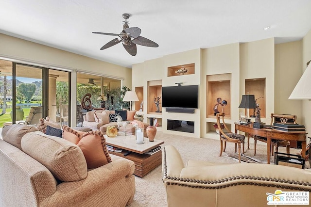 carpeted living room with ceiling fan