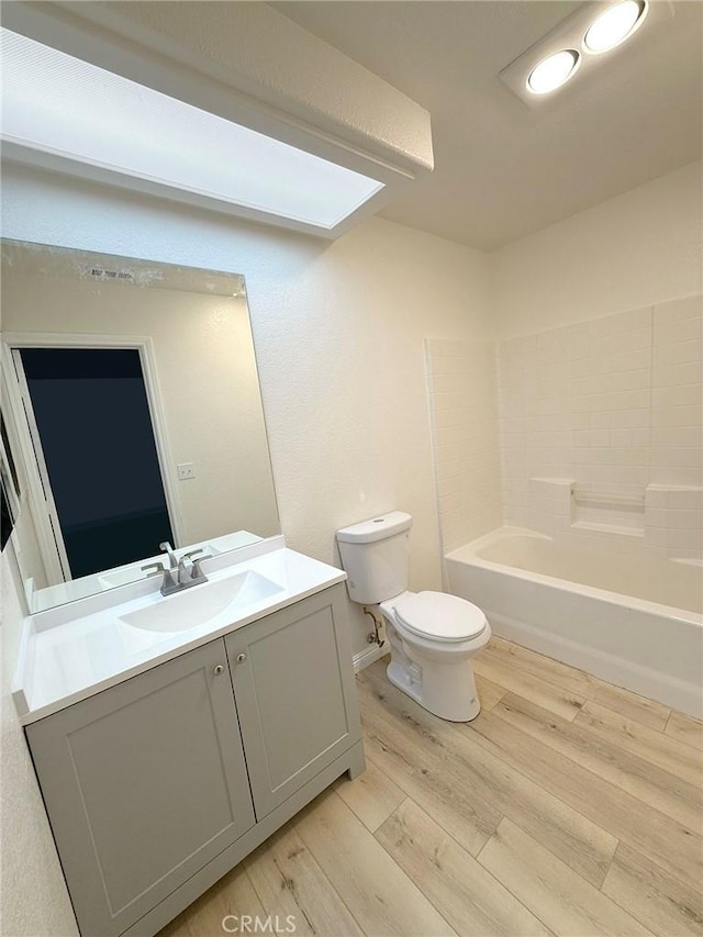 full bathroom with vanity,  shower combination, toilet, and wood-type flooring