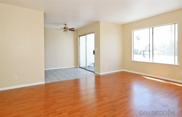 unfurnished room with ceiling fan and light hardwood / wood-style flooring