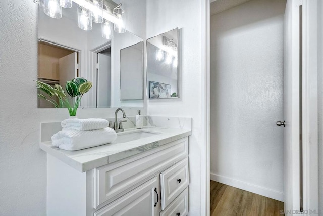 bathroom featuring vanity and wood-type flooring