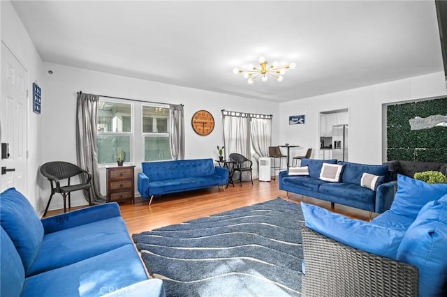 living room with a notable chandelier and hardwood / wood-style flooring