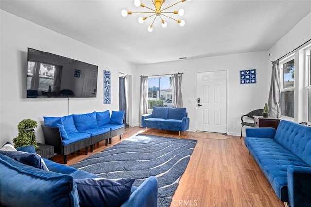 living room with a notable chandelier and hardwood / wood-style flooring