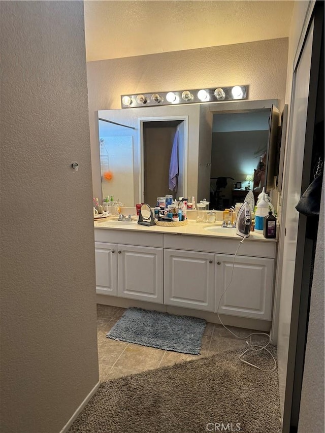 bathroom featuring tile patterned flooring and vanity