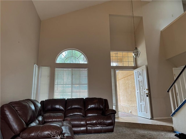 living room featuring carpet floors and high vaulted ceiling