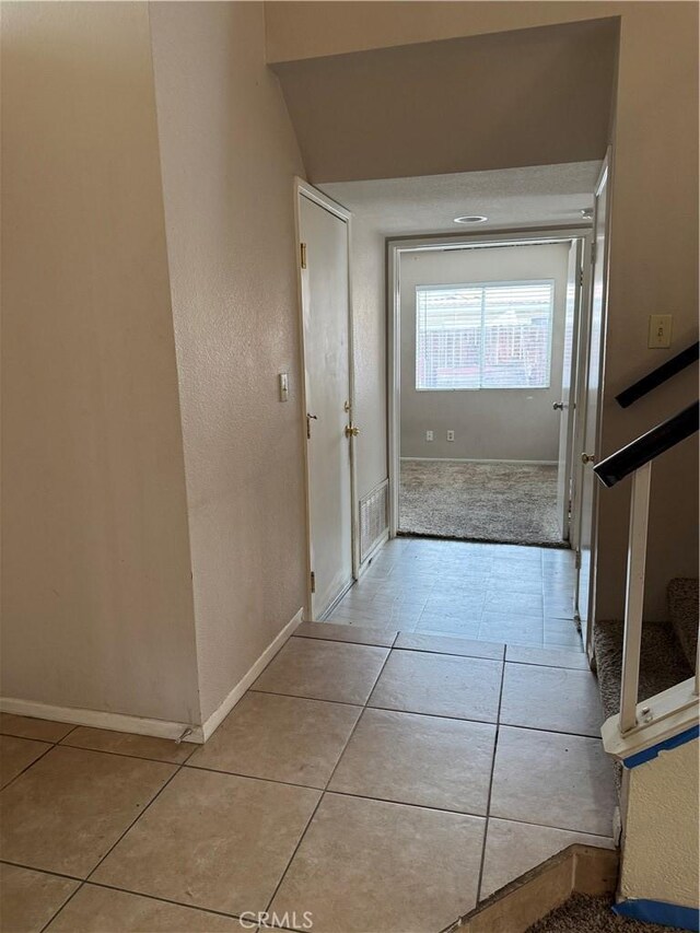 corridor with light tile patterned flooring