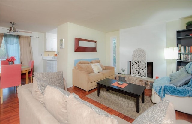 living room with hardwood / wood-style flooring and ceiling fan