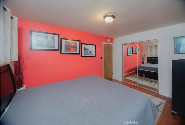 bedroom featuring hardwood / wood-style flooring and a closet