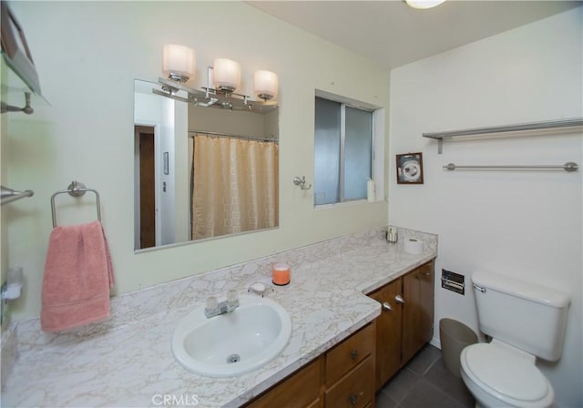 bathroom with vanity, tile patterned flooring, curtained shower, and toilet