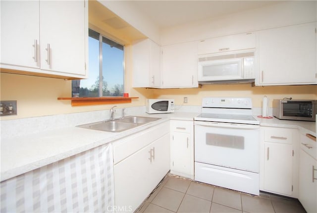 kitchen with white cabinetry, white appliances, sink, and light tile patterned floors