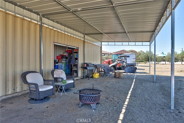 view of car parking with an outdoor fire pit