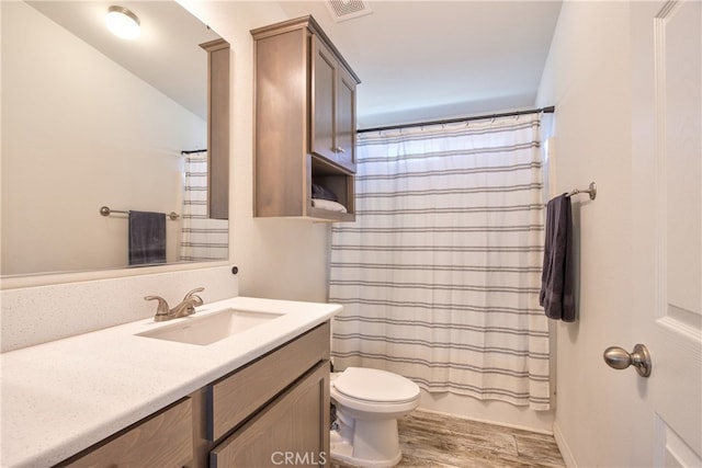 full bathroom with hardwood / wood-style floors, vanity, toilet, and shower / bathtub combination with curtain