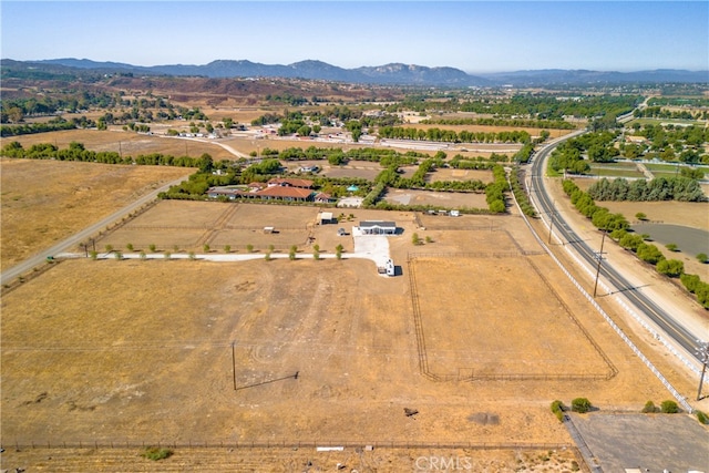 birds eye view of property featuring a mountain view and a rural view