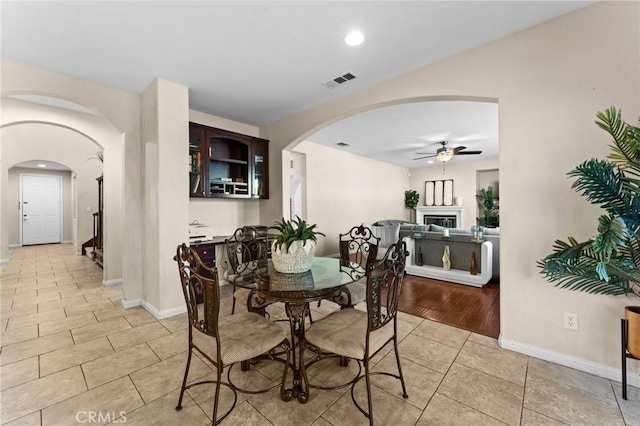 dining room with ceiling fan and light hardwood / wood-style floors