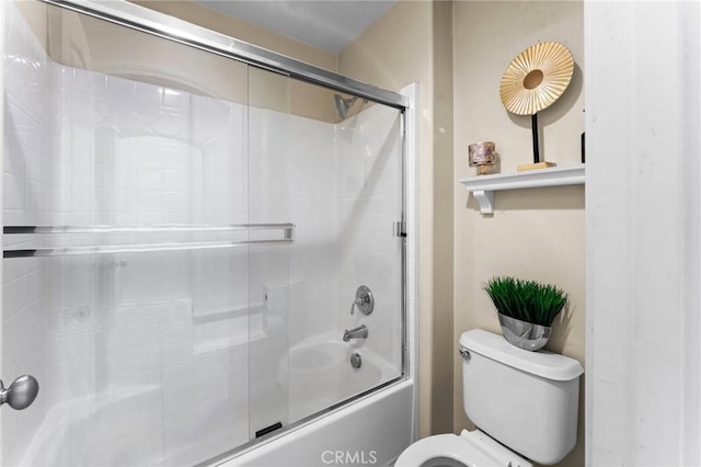 bathroom with shower / bath combination with glass door and toilet