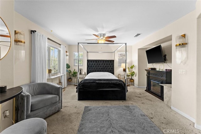 bedroom with ceiling fan and light carpet