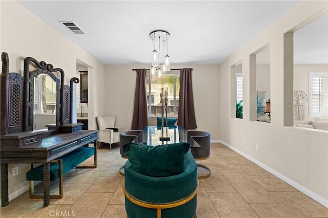 living area with a chandelier and light tile patterned floors