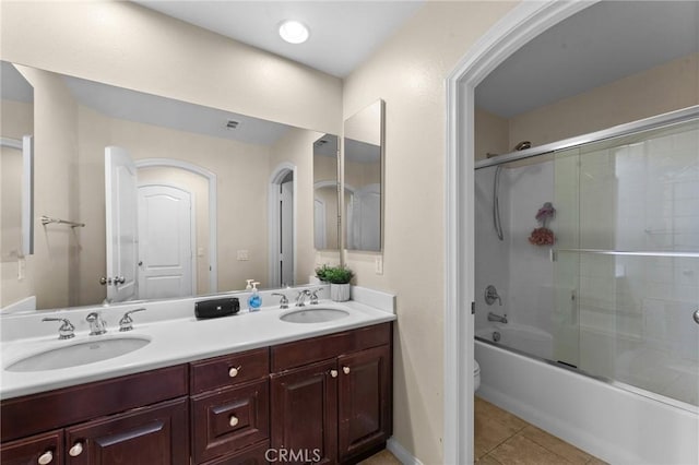 full bathroom with tile patterned floors, vanity, toilet, and combined bath / shower with glass door