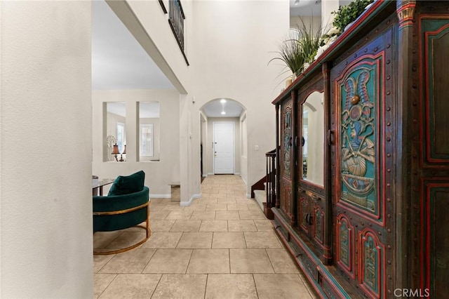 hall featuring light tile patterned floors