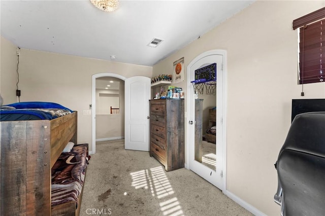 bedroom featuring light carpet