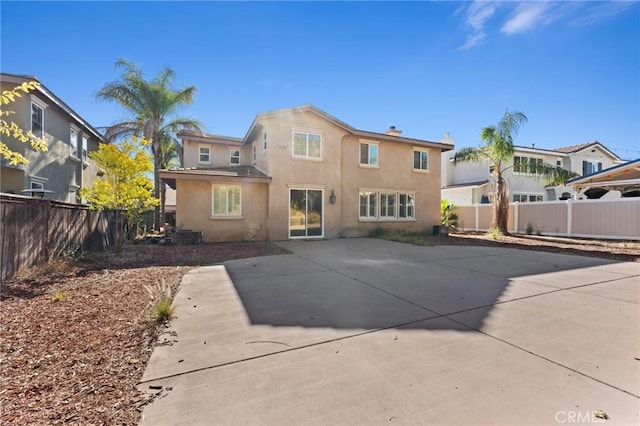 rear view of property featuring a patio area