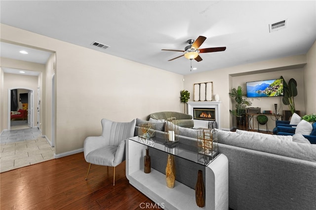 living room featuring hardwood / wood-style flooring and ceiling fan