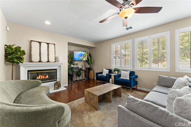 living room featuring ceiling fan and dark hardwood / wood-style floors