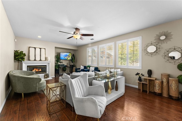 living room with ceiling fan and dark hardwood / wood-style flooring