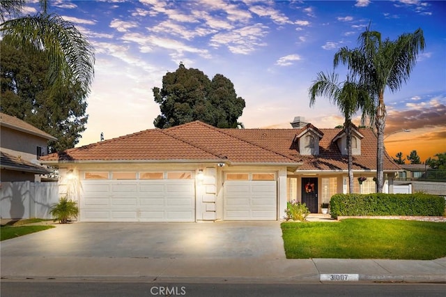 view of front of property featuring a lawn and a garage