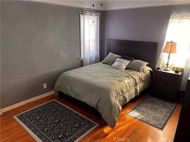 bedroom with wood-type flooring