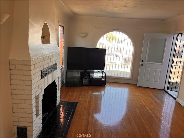 unfurnished living room featuring hardwood / wood-style floors and a fireplace