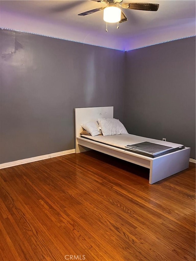 unfurnished bedroom with hardwood / wood-style flooring and ceiling fan