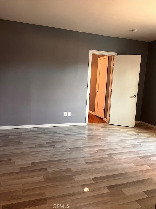 spare room with light hardwood / wood-style flooring