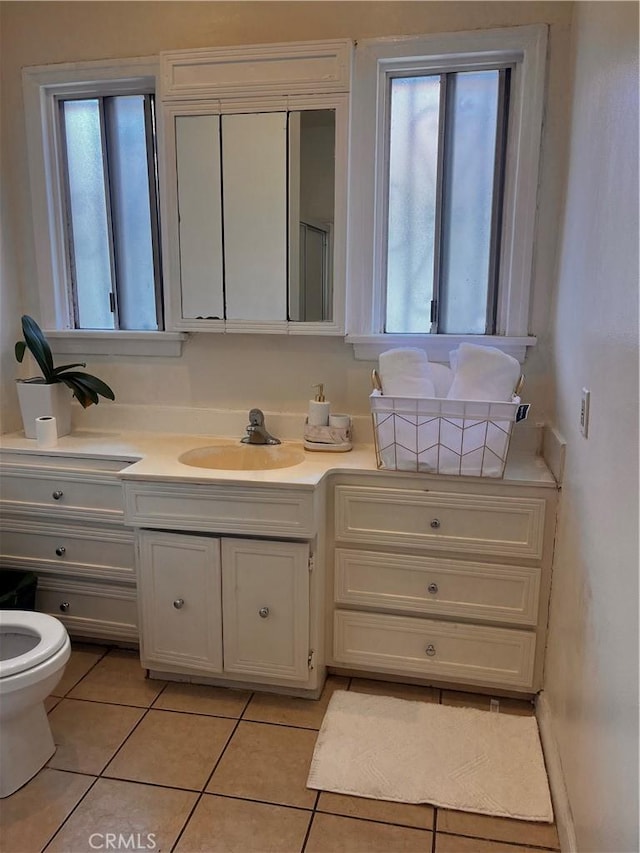 bathroom featuring tile patterned flooring, vanity, and toilet