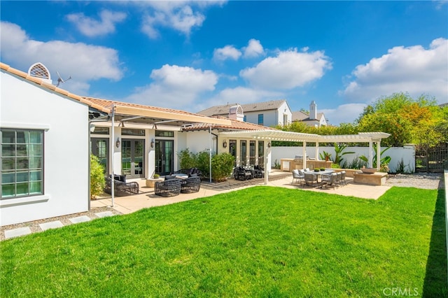 rear view of property featuring a pergola, a patio area, a lawn, and an outdoor hangout area