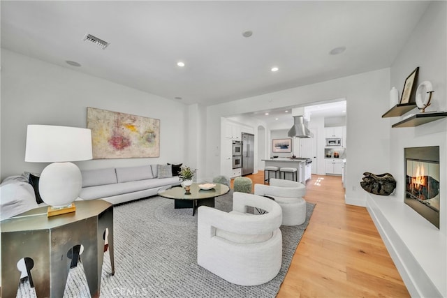 living room with light hardwood / wood-style flooring