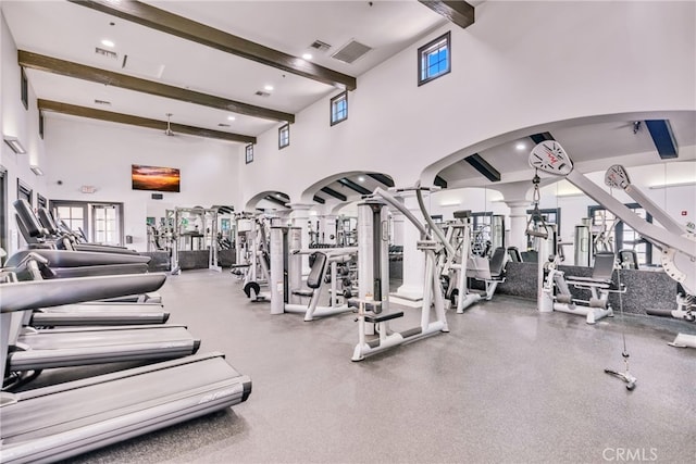 exercise room with a high ceiling