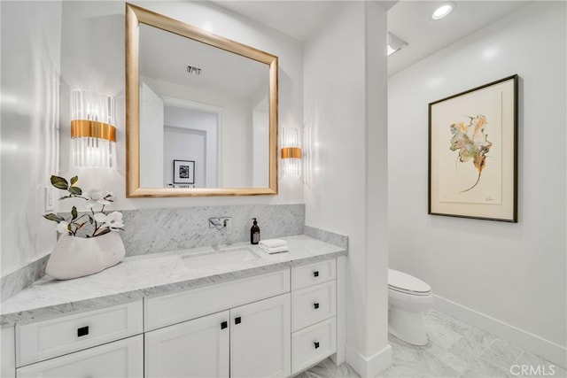 bathroom featuring vanity and toilet