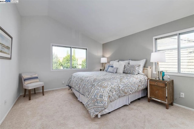 carpeted bedroom with vaulted ceiling