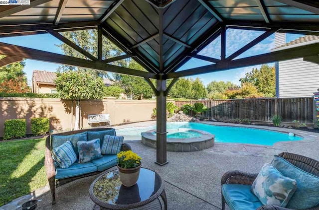 view of swimming pool with a patio area and an in ground hot tub