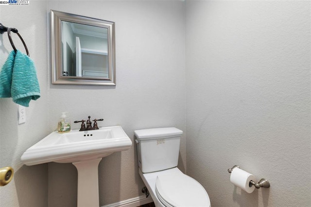 bathroom featuring sink and toilet