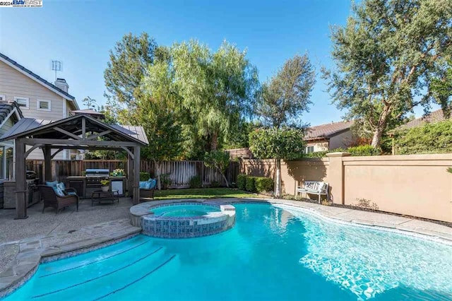 view of pool with a gazebo, area for grilling, an in ground hot tub, and a patio