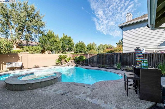 view of pool featuring an in ground hot tub and a patio