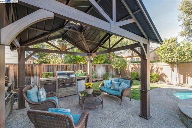 view of patio / terrace featuring outdoor lounge area, a gazebo, grilling area, and exterior kitchen