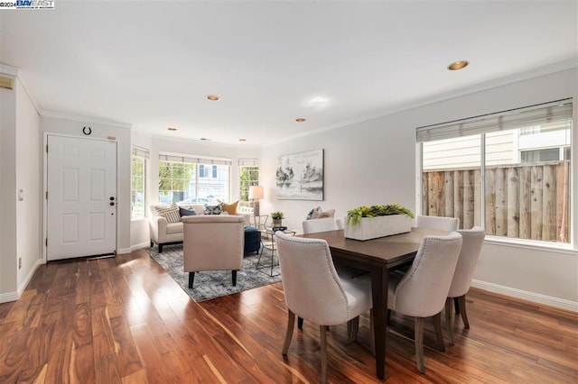 dining area featuring hardwood / wood-style floors and ornamental molding