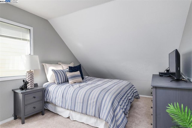 bedroom with light carpet and vaulted ceiling