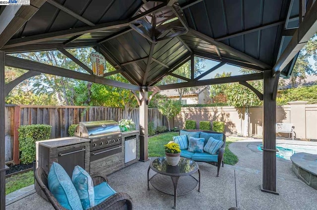 view of patio with a gazebo, a grill, and exterior kitchen