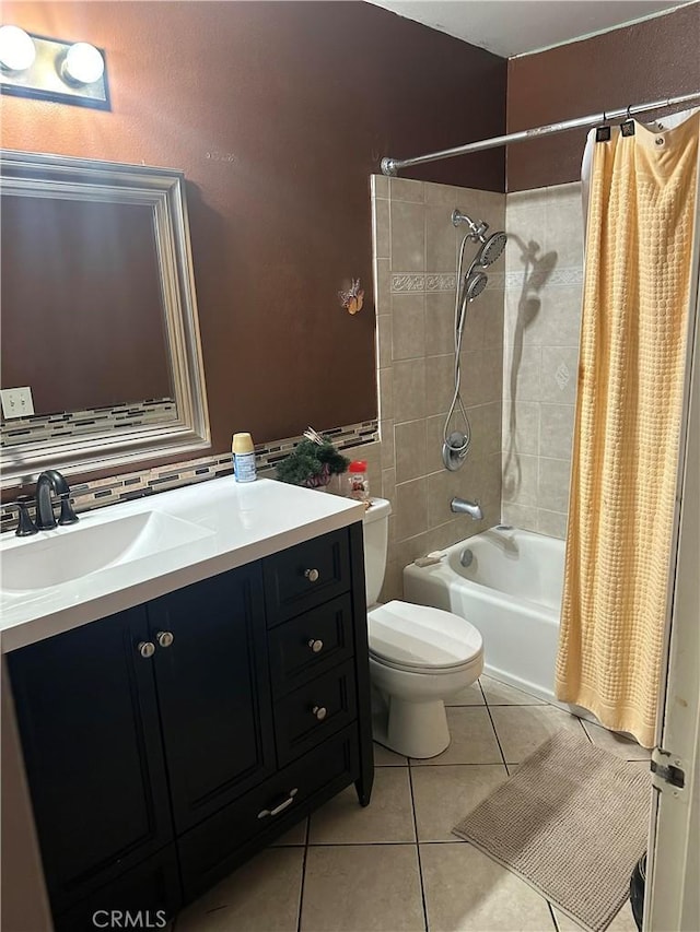 full bathroom with shower / bath combo with shower curtain, tile patterned flooring, vanity, and toilet