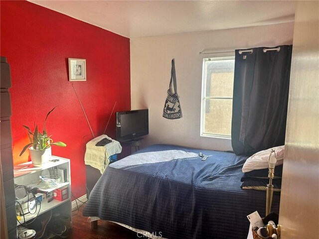 bedroom with hardwood / wood-style flooring