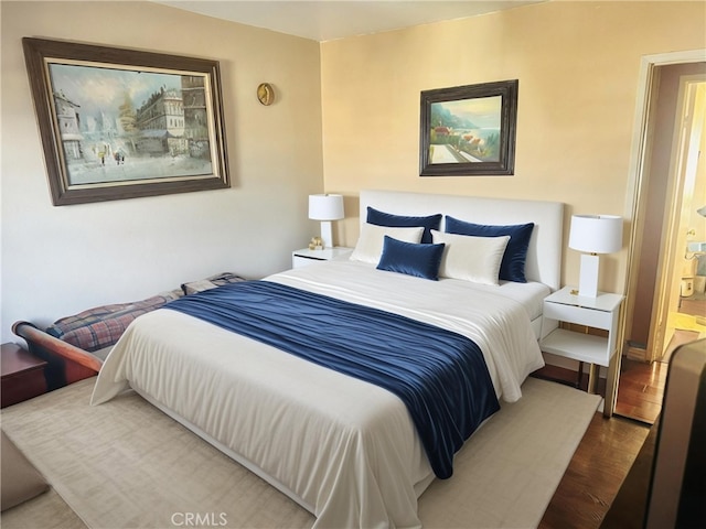 bedroom with dark hardwood / wood-style floors