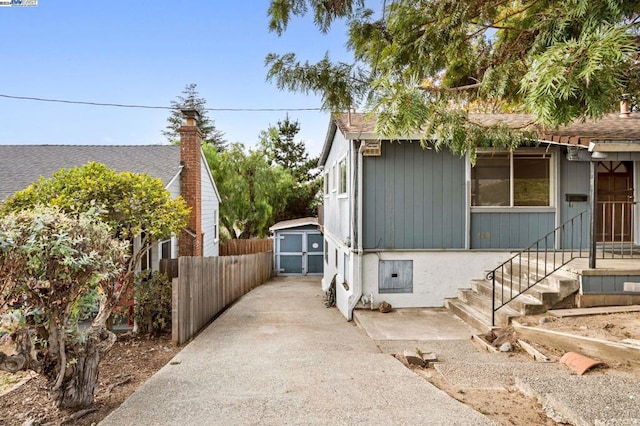 view of side of home featuring a storage unit